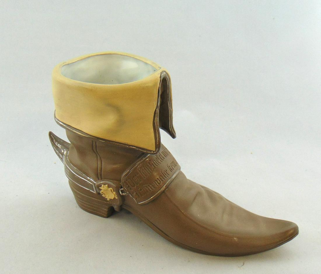 Villerory and Boch boot novelty: Porcelain vase in the form of a boot, marked with the VB shield tradmark on the side, 6" Condition: good with no defects found.