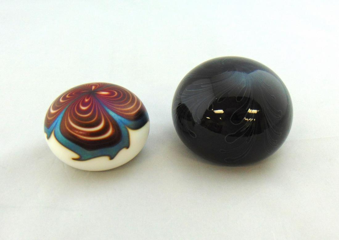 Two Lotton glass Paperweights: Two Lotton glass paperweights including a signed Charles Lotton 1976 opal with red and blue pulled feather, together with a signed Daniel Lotton 1984 dark red with a blue Wisteria, 2 1/2" wide. Condit