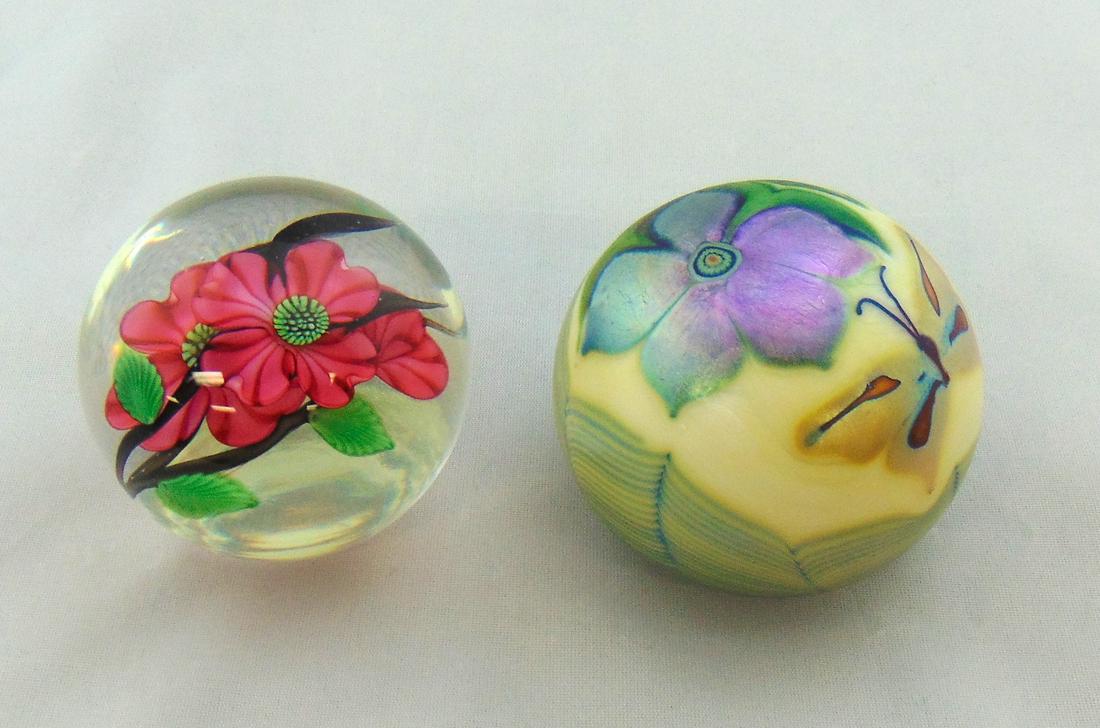 Two Orient and Flume Paperweights: Two Orient and Flume paperweights including an iridescent green with gold butterfly together with a translucent with red flower, both signed, 2 1/2" wide. Condition: good with no defects found.