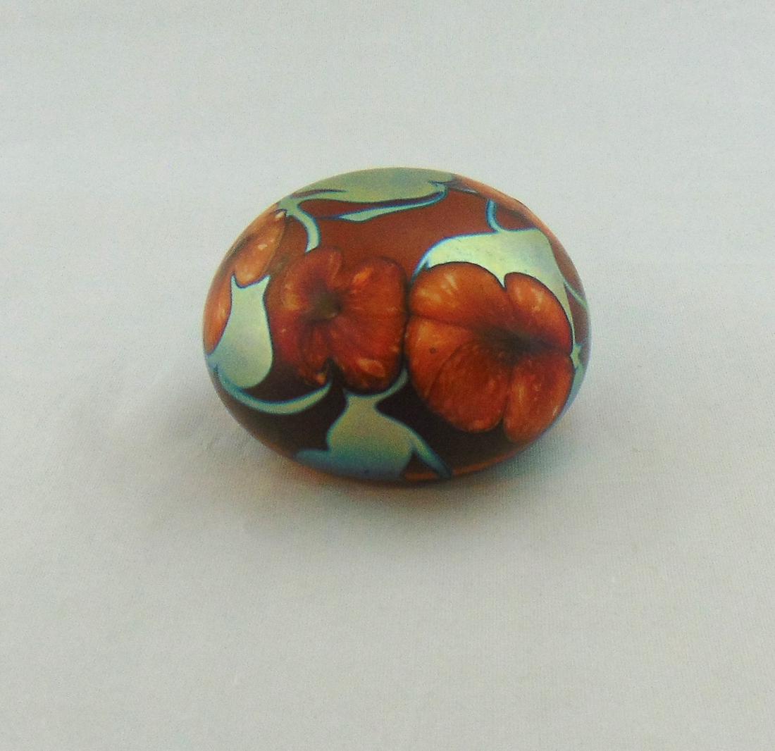 Charles Lotton glass Paperweight: Early Charles Lotton amber and blue paperweight with crimson highlights decorated with red multi flora, signed Charles Lotton Multi Flora 1974, 2 3/4" wide. NOTE: a very early date for Multi Flora Con