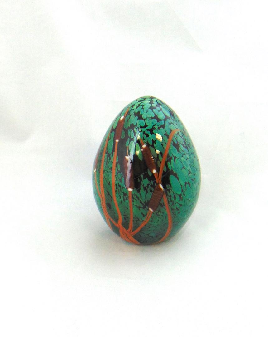 Rick Satava glass paperweight: Egg form in spattered green glass decorated with stemmed cattails, signed R. Satava 8-86, 4 1/2" ht. Condition: good with no defects found.