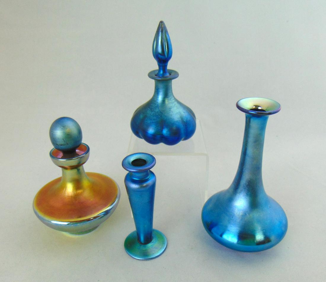 Group of four Steuben bottles: Including a melon ribbed shape number 2183, a gold Aurene number 3423, and two without stoppers, tallest 5" ht. Condition: good two without stoppers, gold with marriage.