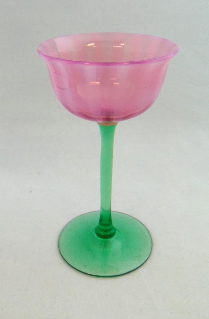 Steuben Oriental Poppy goblet: Green footed goblet with a opalescent pink striated goblet, 5 3/4" ht. Condition: good with no defects found