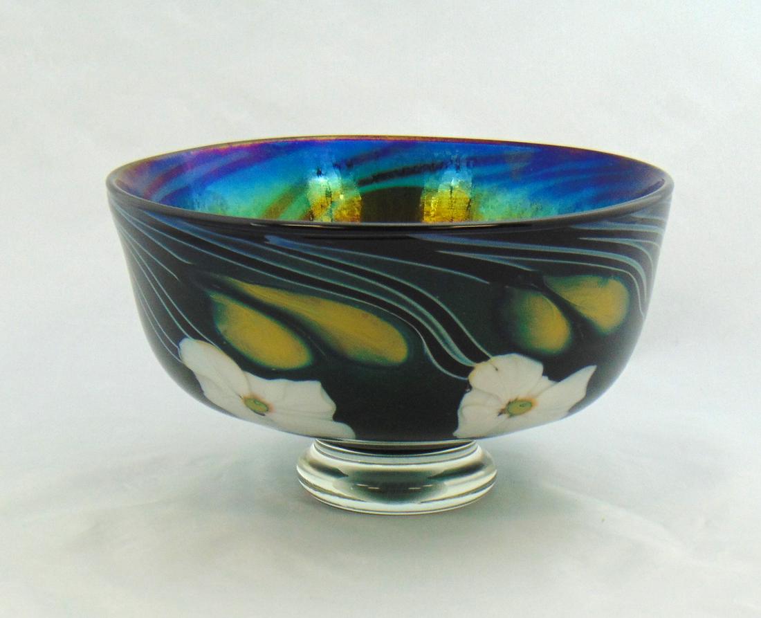 Charles Lotton art glass Bowl: Footed art glass bowl in green aventurine glass decorated with white Multi Flora and dark blue vines, signed Charles Lotton 1984, 7" wide. Condition: good with no defects found.