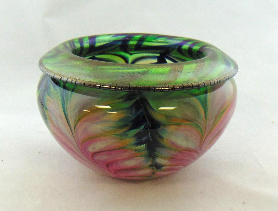 Daniel Lotton art glass vase: Ovoid form with a rolled over rim in translucent green glass decorated with a pink pulled feather, signed Daniel Lotton 1989, 7 1/2" wide by 4 1/2" ht. PROVENANCE: Earlys Auction to the Black Collecti