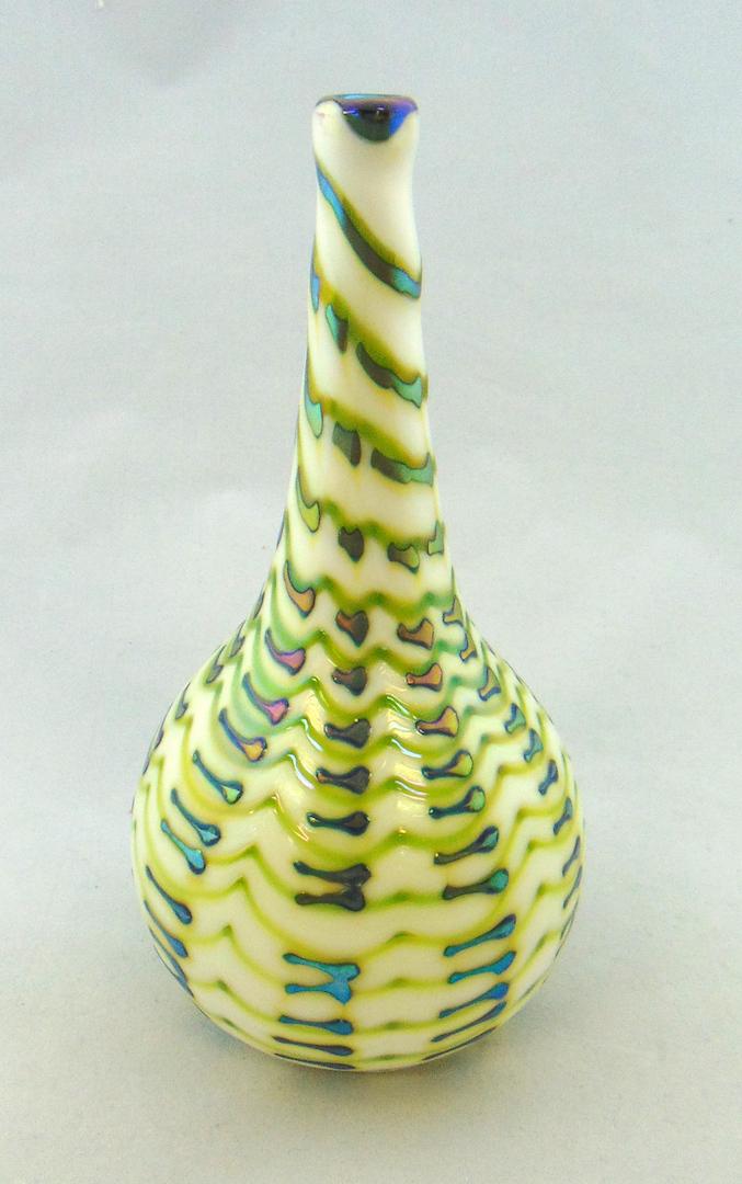 Charles Lotton Zipper glass vase: Bulbous stick form in opal glass decorated with a green and iridescent blue zipper pattern, signed Charles Lotton 1977, 8" ht. Condition: good with no defects found.