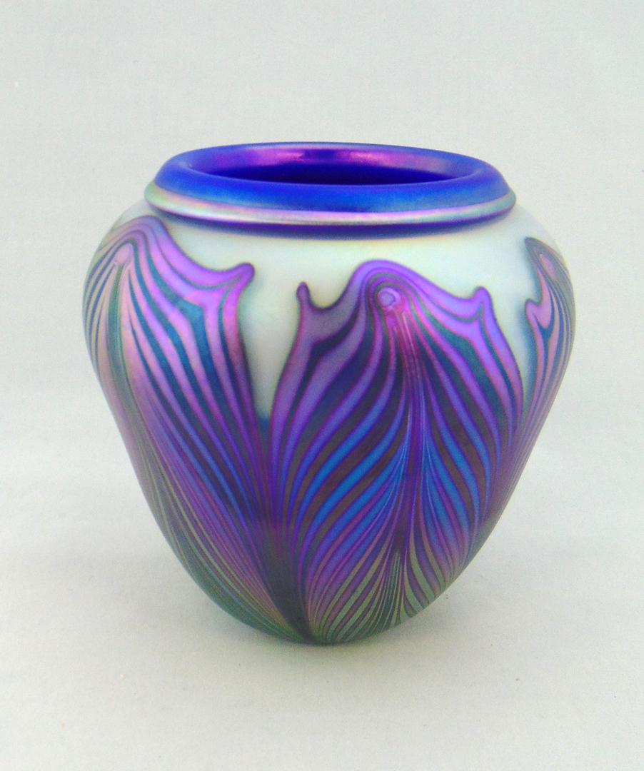 Charles Lotton Blue Hooked Feather: Ovoid form in opal glass with an iridescent blue and iridescent gold pulled feather, signed Charles Lotton 2003, 6" ht. Condition: good with no defects found.