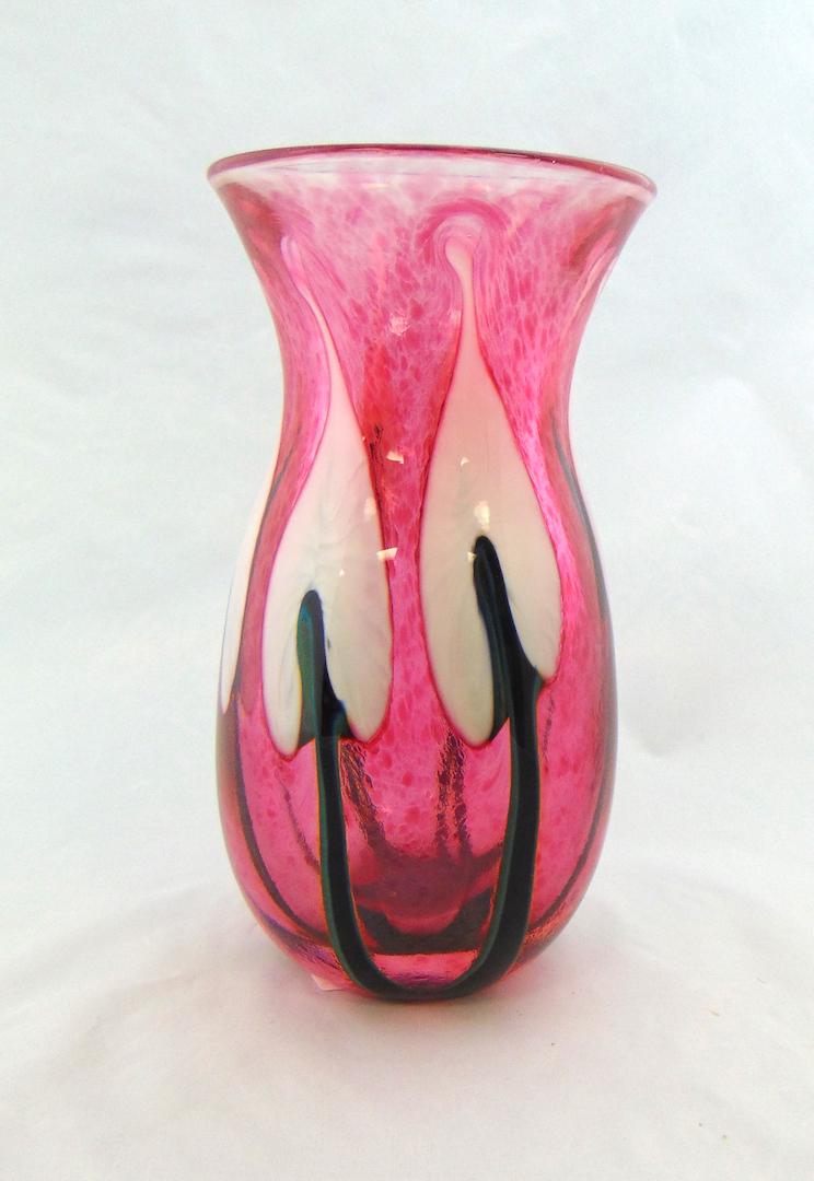 John Lotton Cranberry glass vase: Corset form in translucent cranberry glass decorated with white arrow point flowers, signed John Lotton 1993, 6 1/2" ht. Condition: good with no defects found.