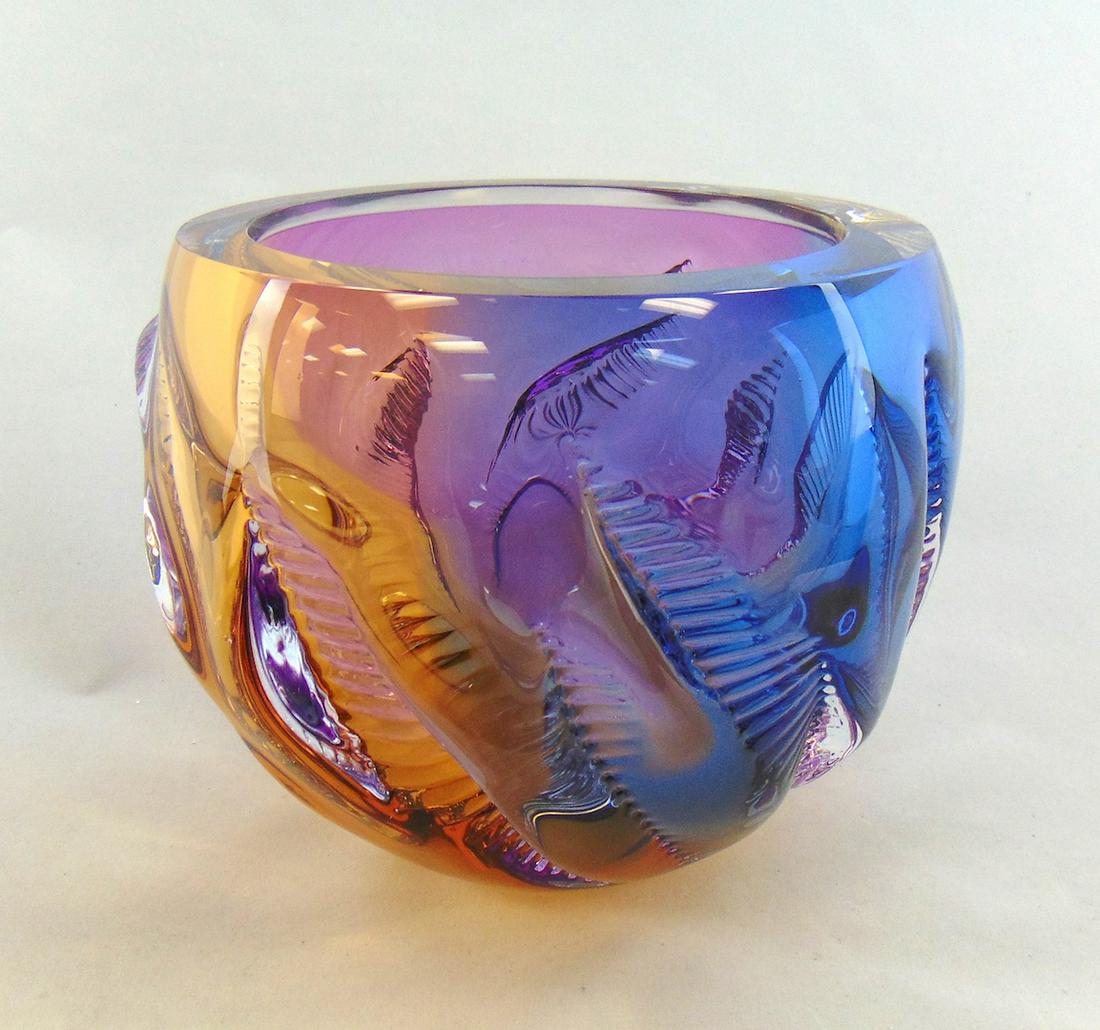 Leon Applebaum art glass bowl: Ovoid bowl in heavy translucent glass accented with zipper scales and adorn with a rainbow of purple, yellow, blue and orange, signed Leon Applebaum, 6 1/2" ht. Condition: good with no defects found.