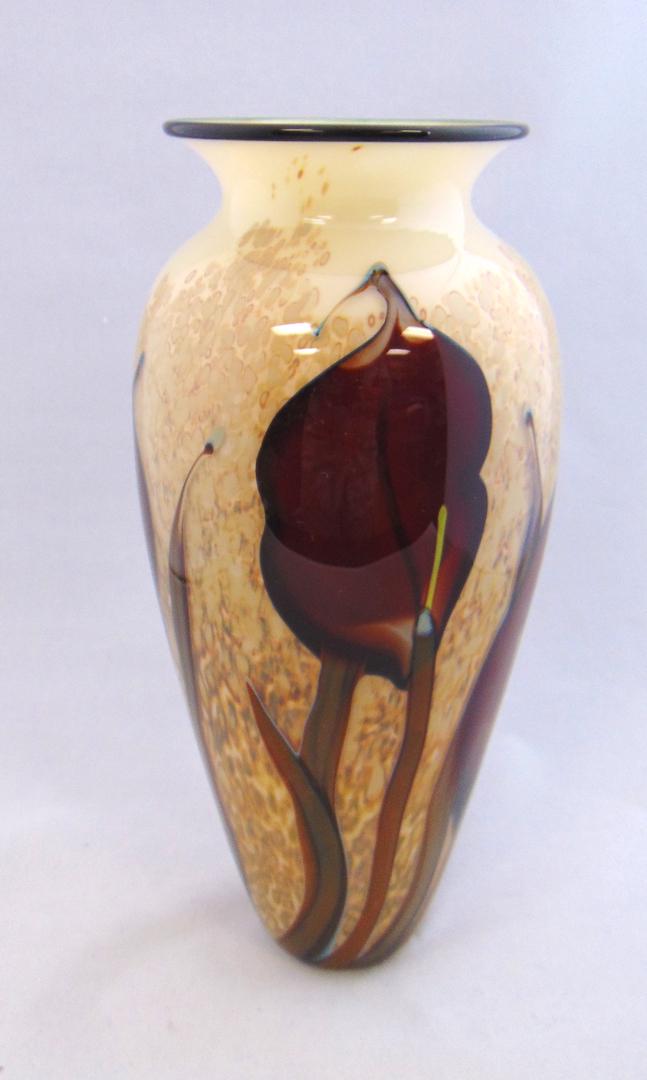 Rick Satava art glass vase: Cylindrical shouldered form in cream glass decorated with large stemmed red flowers, signed R Satava -95, 11 1/2" ht. Condition: good with no defects found.