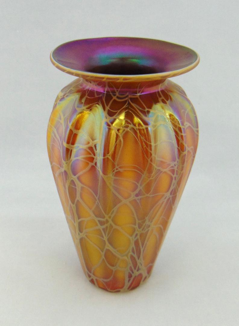 Stuart Abelman art glass vase: Heavy ribbed cylindrical vase in caramel glass with a random gold web design and rich purple interior, signed Abelman, 8 1/4" ht. Condition: good with no defects found.