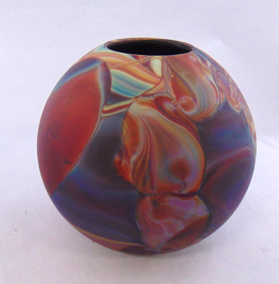 Fred Warren art glass vase: Ovoid form agate vase in shades of red blue and turquoise, signed Fred Warren, 5 1/2' ht. Condition: good with no defects found.