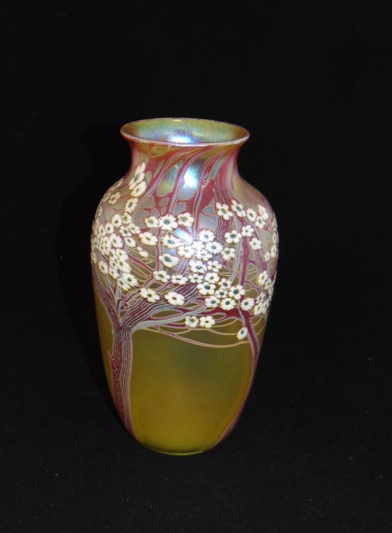 Orient and Flume Wisteria glass vase: Shouldered form in gold glass decorated with variegated branches of White Millefiori Wisteria, signed Orient and Flume, 8 1/2" ht. Condition: good with no defects found.