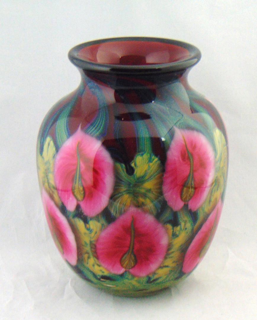 Daniel Lotton bing cherry glass vase: Double wall ovoid shouldered form in bing cherry red decorated with pink flowers on blue and green stems, signed Daniel Lotton 2003, 9 1/2" ht. Condition: good with no defects found.