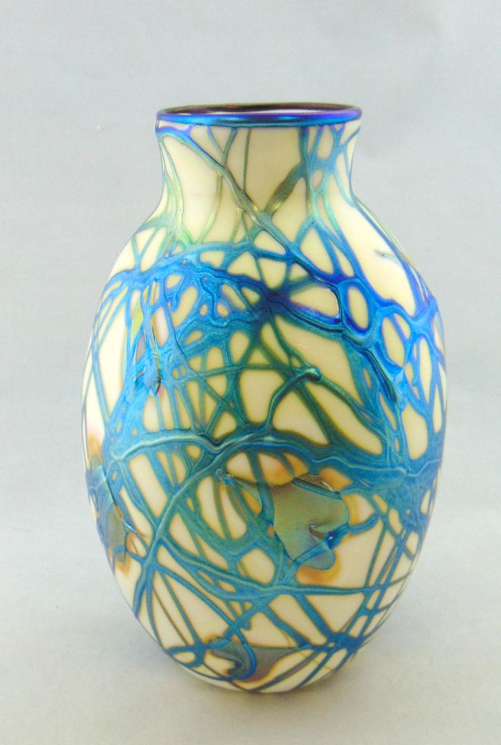 Charles Lotton Heart and Vine vase: Ovoid form in opal glass decorated with a random iridescent blue heart and vine, signed Charles Lotton 1981, 9" ht. Condition: good with no defects found.