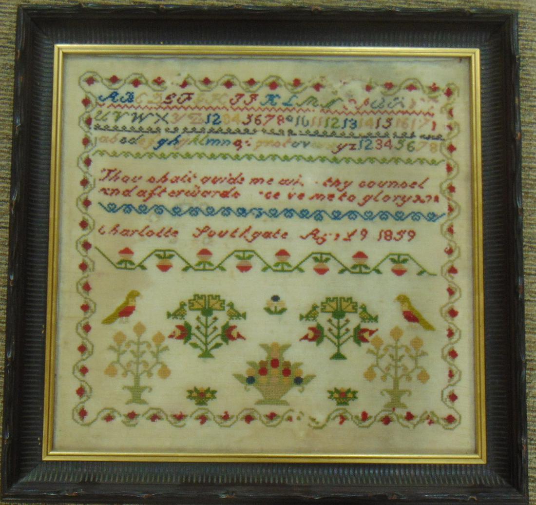 Large Victorian needlepoint sampler: Rectangular sampler with colorful letters and numbers highlighted with trees, birds, and flower baskets and framed with a red and green garland, done by Charlotte Southgate 1859, with frame 23" by 23.