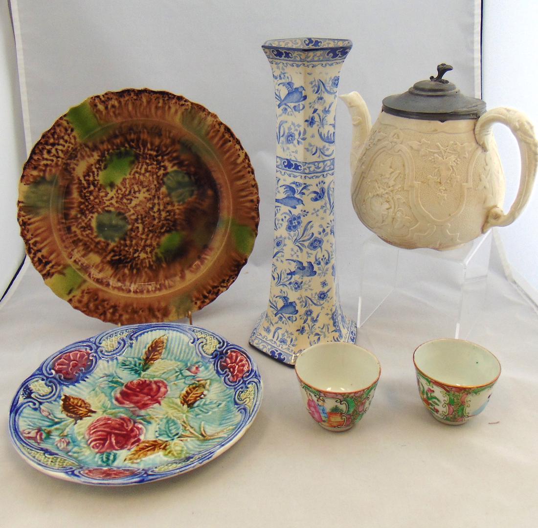 Group of Vintage porcelain: Including a sponge wear and Majolica plate, a Cream ware Teapot, a blue transfer Burslem vase with birds, and two oriental tea cups. Tallest 11 1/2" ht. Condition: line on the bottom of the tea pot.
