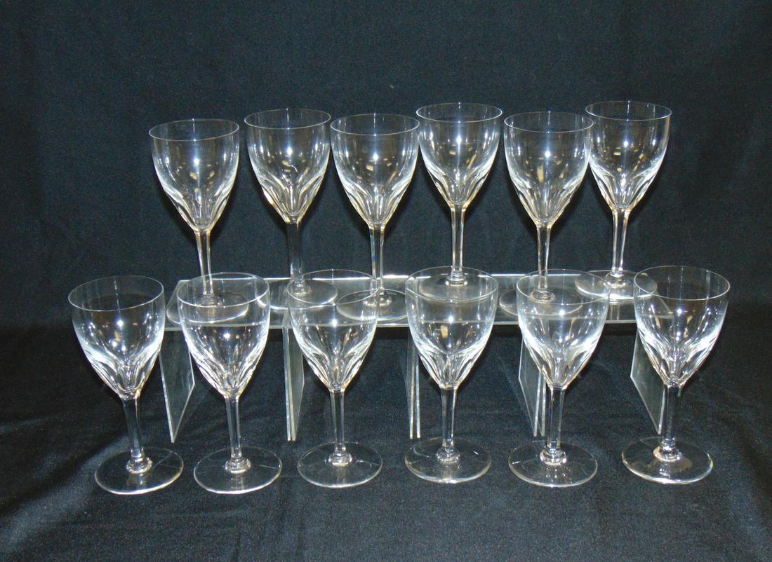 Set of 12 Baccarat Genova water goblets: Faceted cut crystal claret wines in the Genoa pattern, each signed Baccarat, 7 1/2" ht. Condition: good with no defects found.