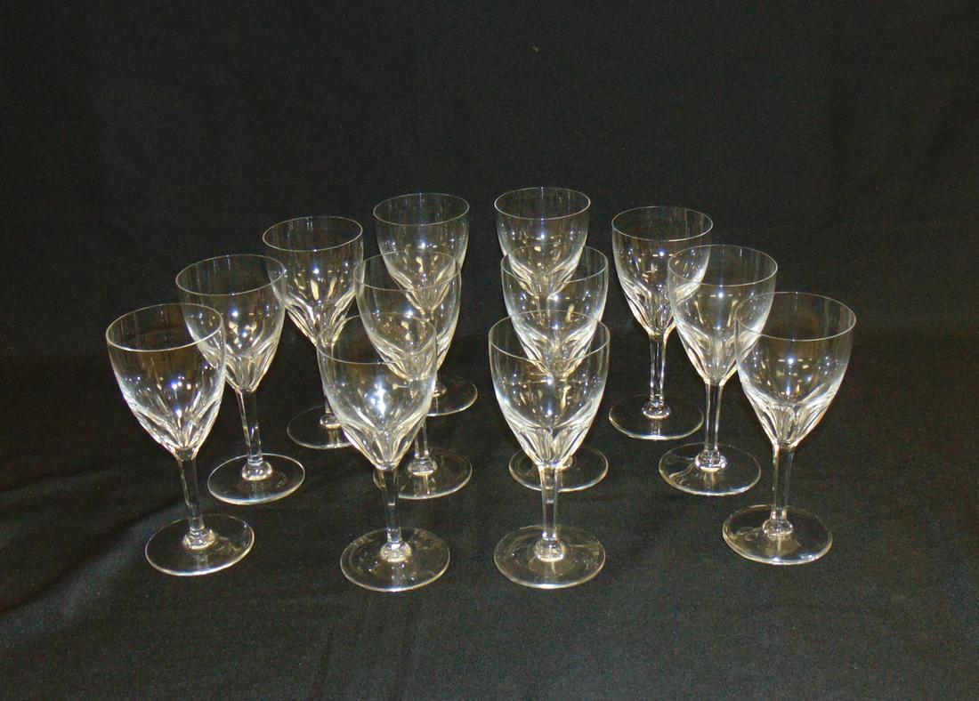 Set of 12 Baccarat Genova claret wines: Faceted cut crystal water goblets in the Genoa pattern, each signed Baccarat, 6 1/2" ht. Condition: good with no defects found.