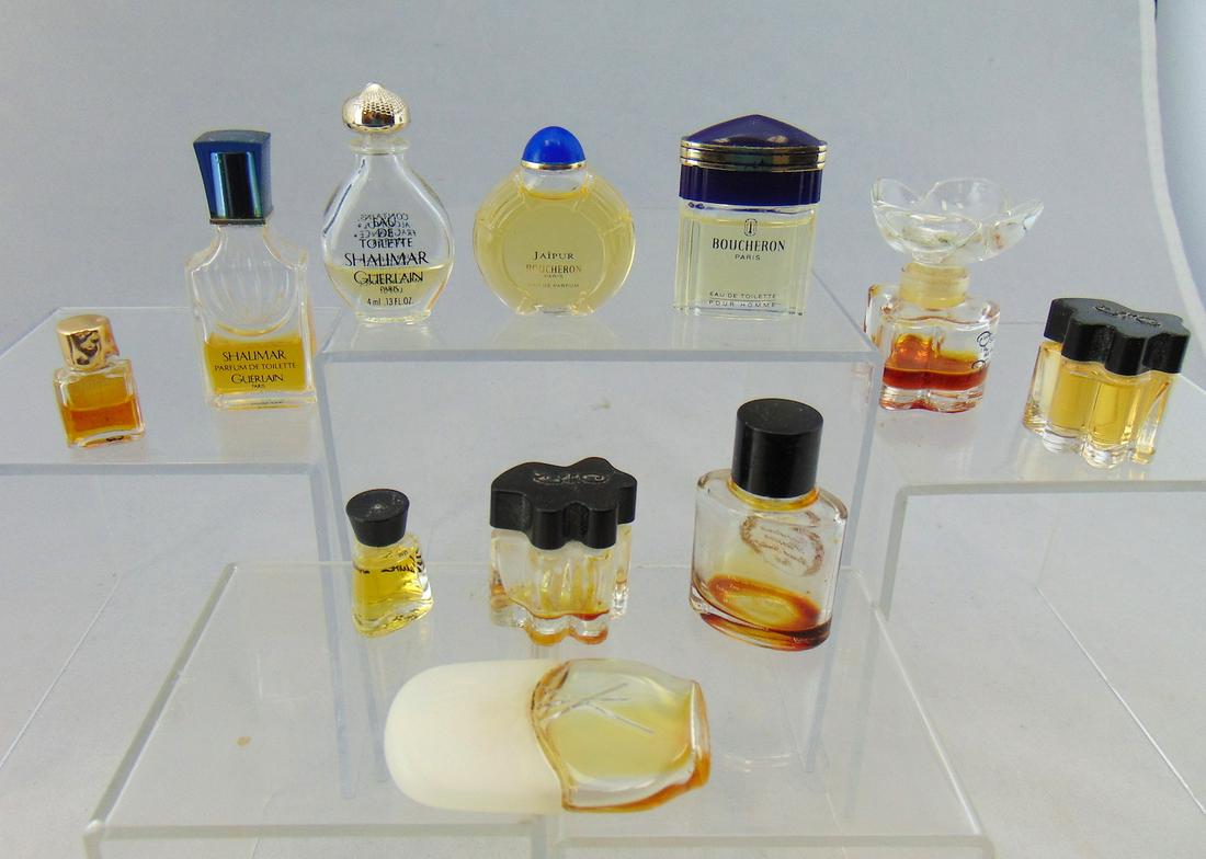 Group of diminutive perfume bottles: Including Oscar de la Renta, Guerlain Shalimar, Replique, Fauve, Jaipur Boucheron, Replique, and more. Largest 2 1/2" ht. Condition: good, most with perfume.