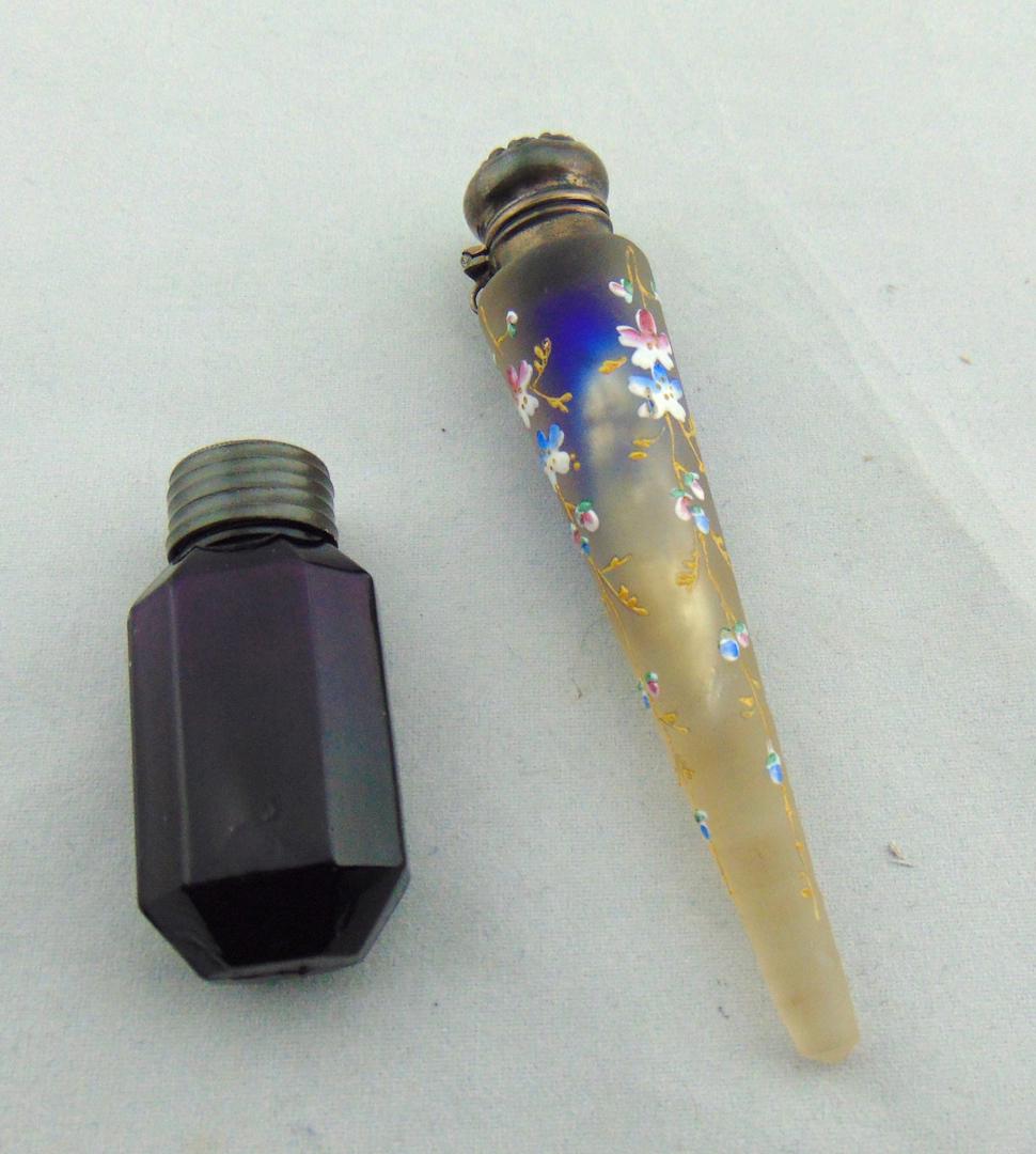 Two Vintage perfumes: Including a tear drop form frosted blue with enameled flowers, together with a faceted early purple bottle, tallest 4 1/4" ht. Condition: good with no defects found.