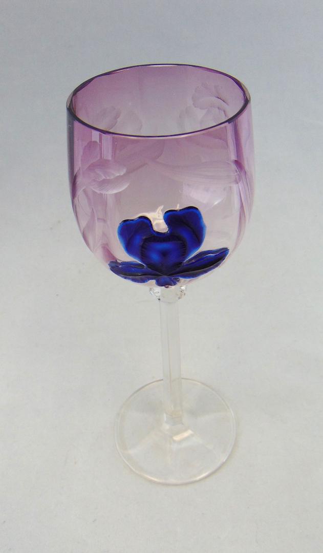 Moser marquetry glass goblet: Purple optic ribbed goblet with etched iris and a central blue marquetry iris, 7 3/4' ht. Literature: "Moser Artistic Glass" book II by Baldwin page 123. Condition: good with no defects found.