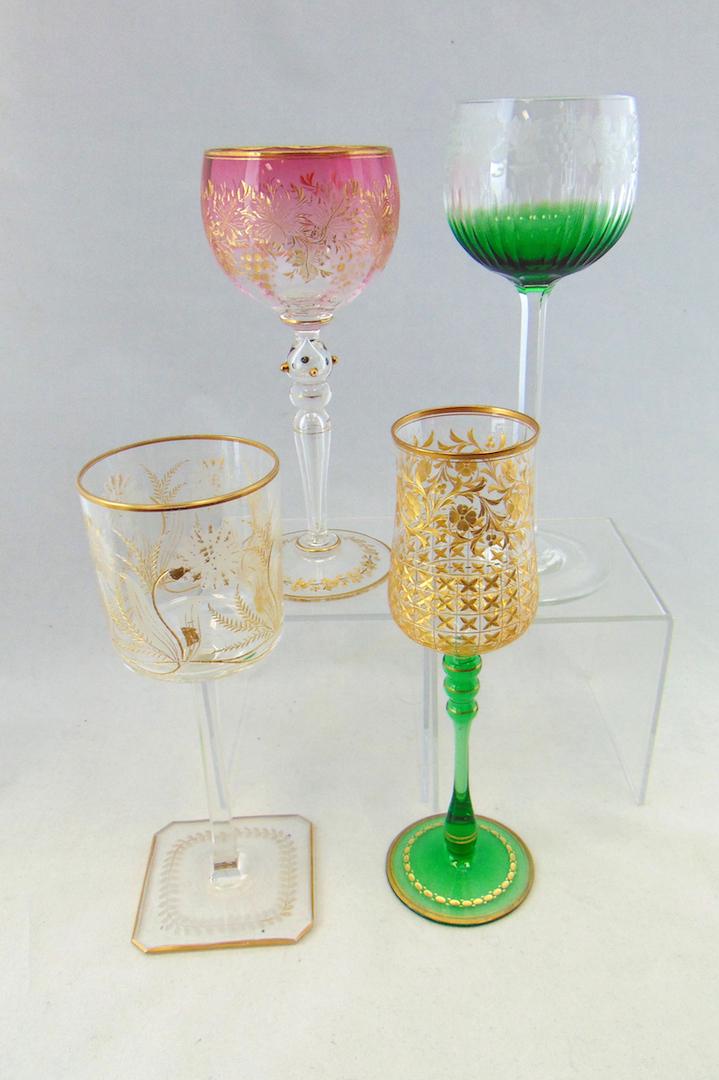 Four etched and enameled goblets: Including a green and cranberry Moser with etched grapes, a square footed translucent with gilt and etched flowers and a green stem with lattice, 7 3/4" ht. Condition: good with no defects found.