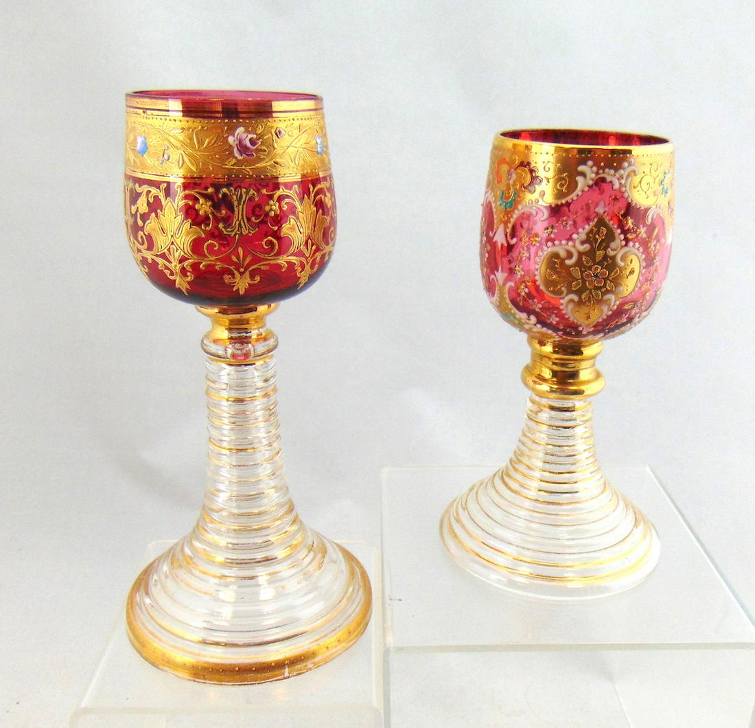 Two cranberry Moser glass goblets: Each with spiral stems and decorated cranberry cups, tallest 7 1/2" ht. Condition: good with no defect found.
