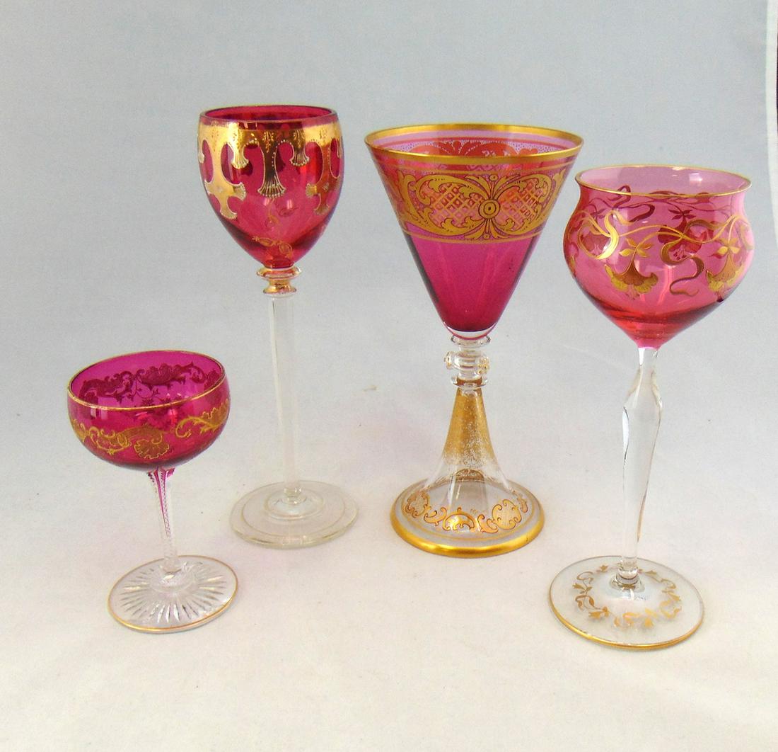 Four cranberry and gilt glass goblets: Various patterns and makers, tallest 8 1/4" ht. Condition: good with no defects found