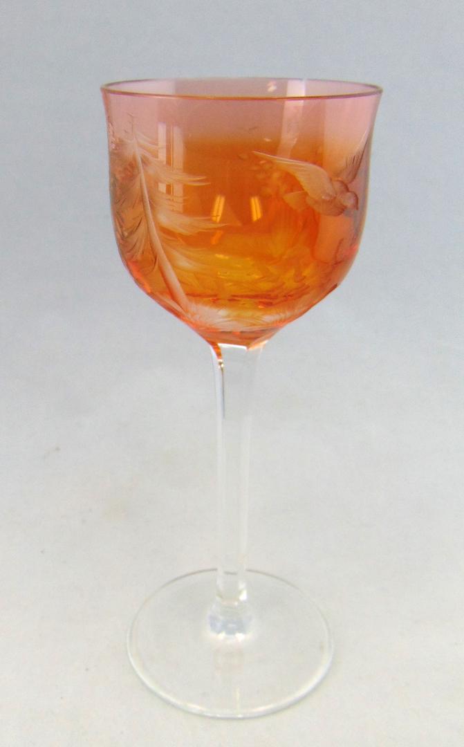 Moser orange cut glass goblet: Orange cut glass goblet decorated with a cut bird and forest scene, signed Moser 7 3/4' ht. Condition: good with no defects found.