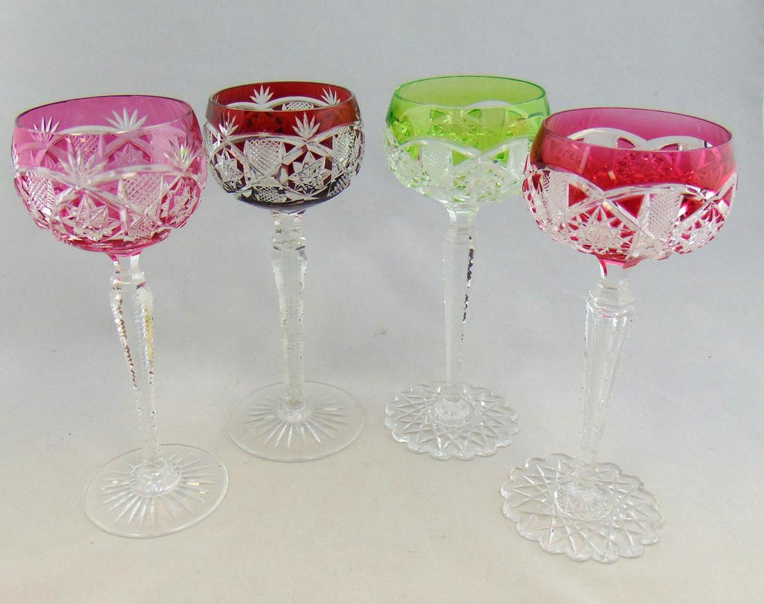 Four Val St Lambert cut goblets: Four Val St Lambert glass goblets in the Saarbrucken or Belfort pattern one in ruby, one in green and two in cranberry, 7 1/2" ht. Condition: good with no defects found