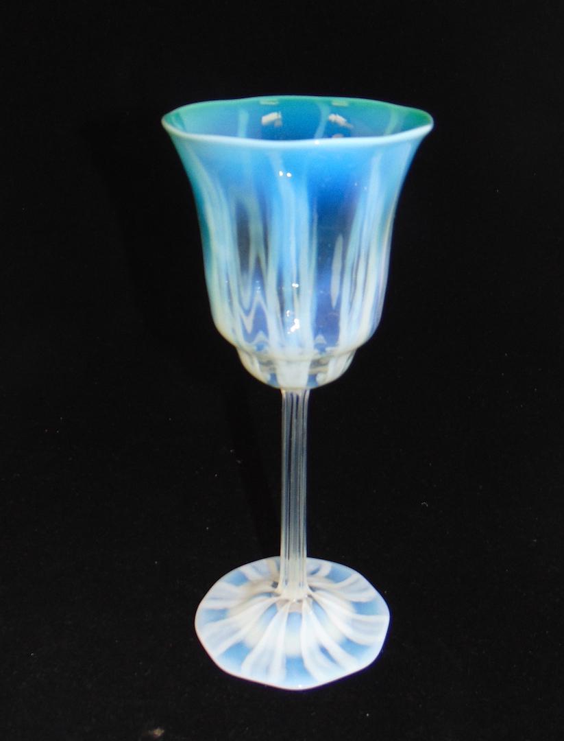 Tiffany green pastel glass goblet: Tall reeded stemmed goblet with a green opalescent bowl, signed L. C. Tiffany Favrile, 8 1/2" ht. Condition: good with no defects found