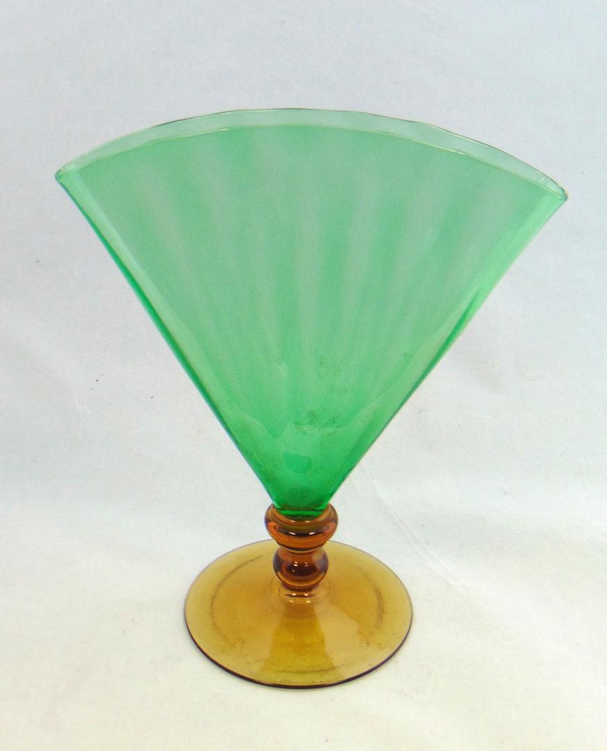 Steuben Pomona Green fan vase: Optic ribbed Pomona Green fan vase with an amber foot, 8" ht. Condition: good with no defects found.