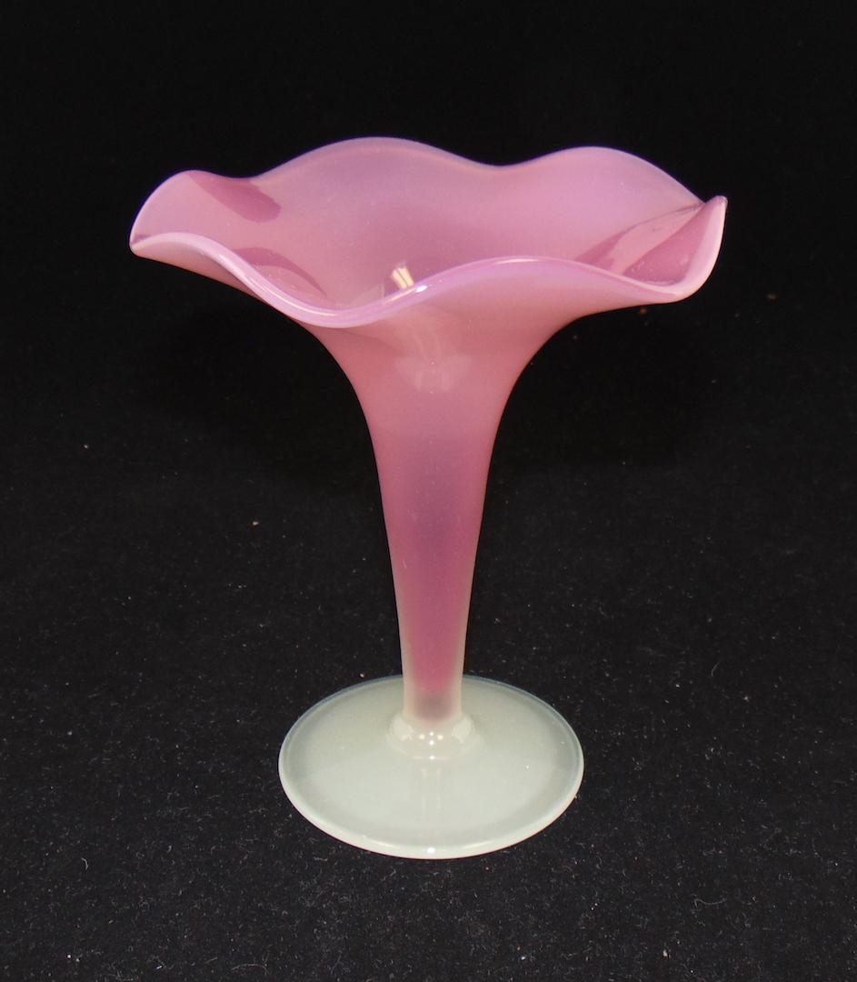 Steuben Rosaline art glass vase: Footed trumpet form with a scalloped rim in Rosaline glass with an alabaster foot, 6" ht. Condition: good with no defects found.