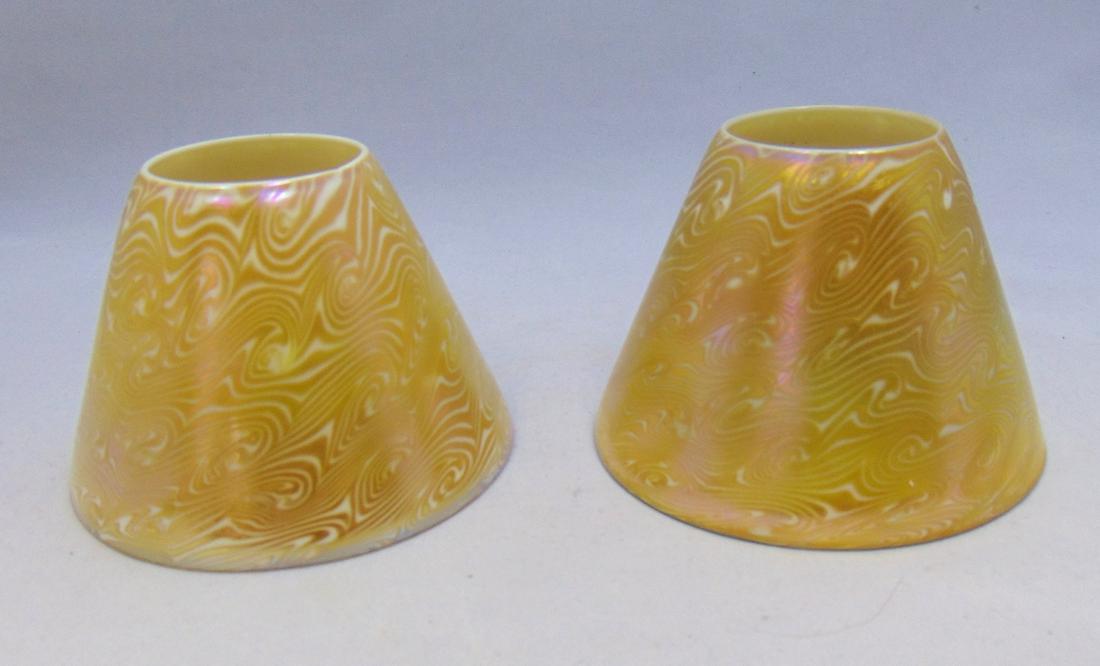 Two Quezal art glass shades: Tee pee form in opal glass decorated with an iridescent coil design, both signed Quezal 3 1/2" ht. Condition: good with no defects found.