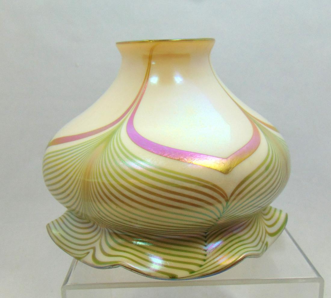 Fostoria art glass shade: Green drag loop on an opal ground with a rich iridescent gold interior, excellent color, 4 1/2" ht by 6" wide. LITERATURE: see Collection Art Nouveau Shades by Roberts page 70 number 288. Condition: g