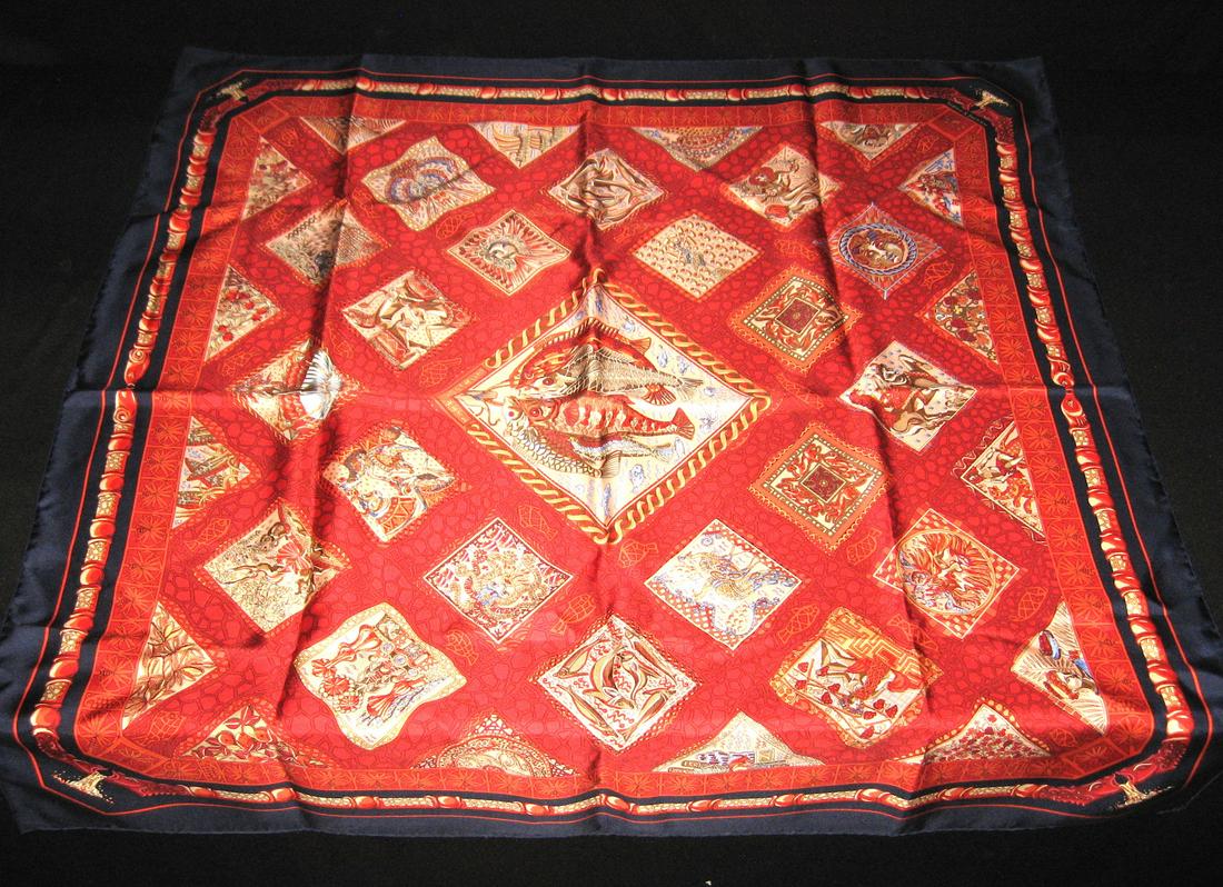 Hermes silk scarf: Mare Nostrum red scarf with square medallions of animals fish and zodiac signs, marked Hermes 36 by 36. Condition: good with no defects found.