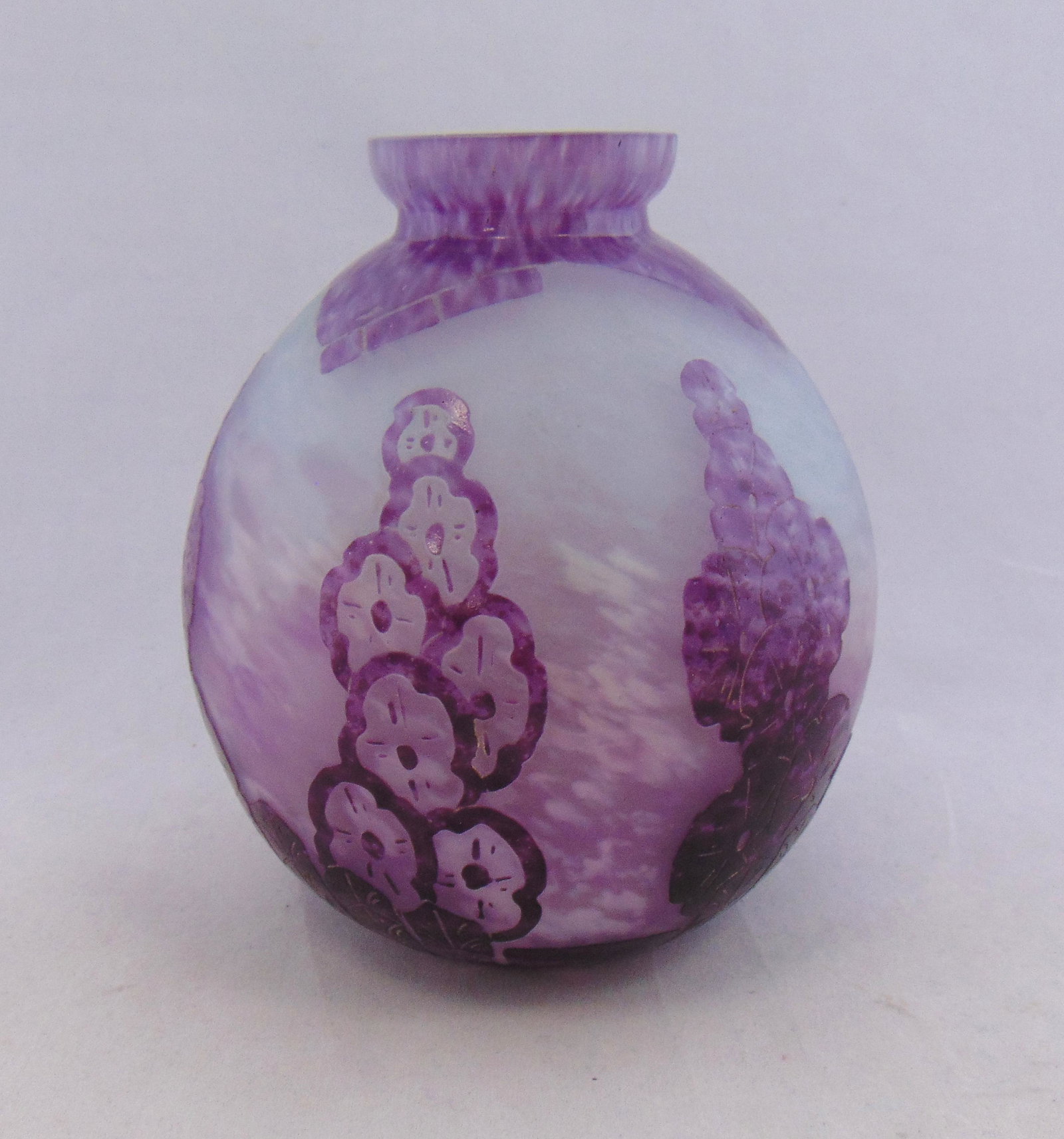 Le Verre Francais French cameo vase: Ovoid form in mottled purple glass decorated with a art deco flower in the "Draperie" pattern, signed Charder 6 1/2' ht. Condition: good, one small chip on the rim.