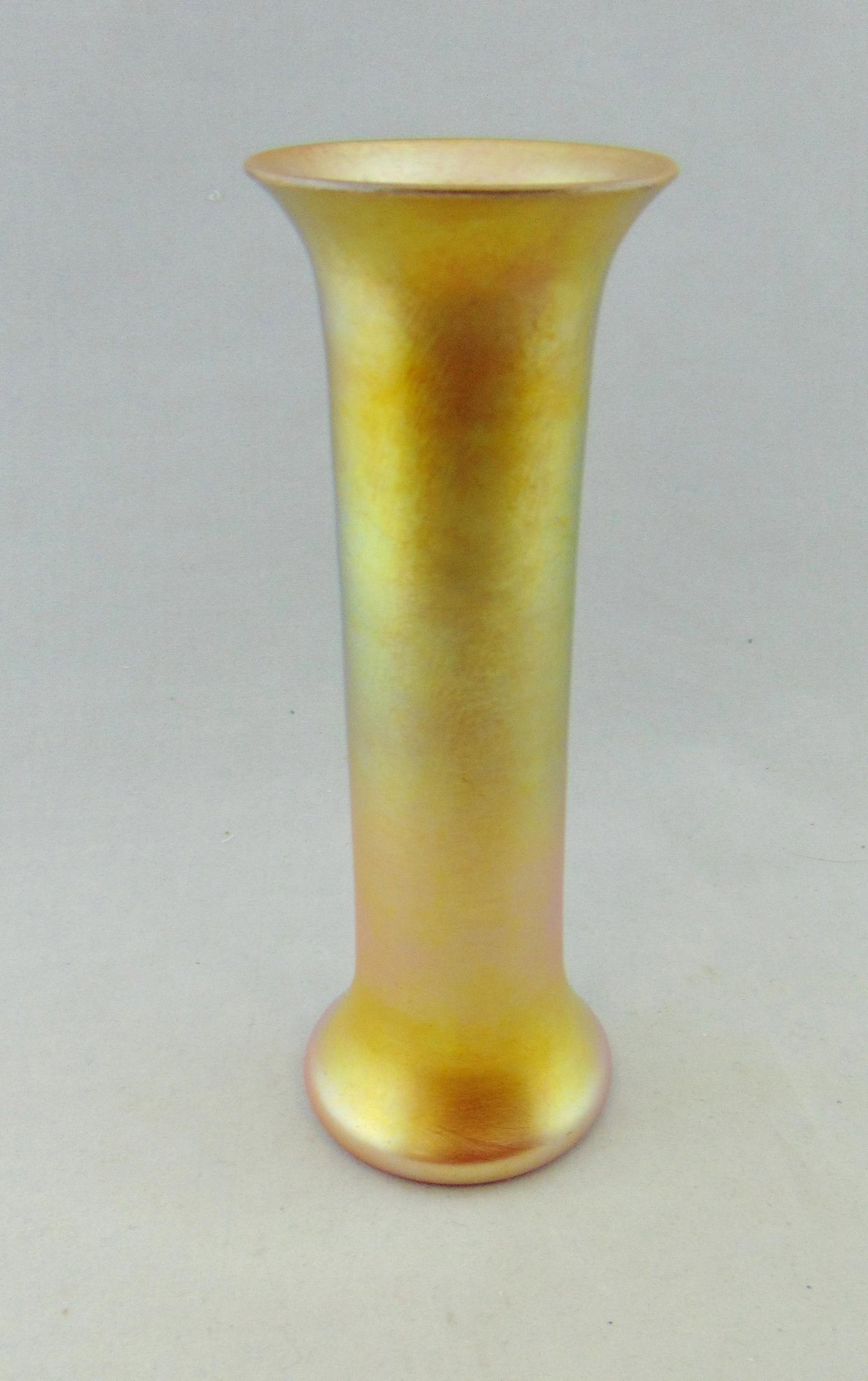 Durand iridescent Gold glass vase: Durand cylindrical form vase in a bright iridescent marigold, shape 1714, 7 3/4' ht. Condition: good with no defects found
