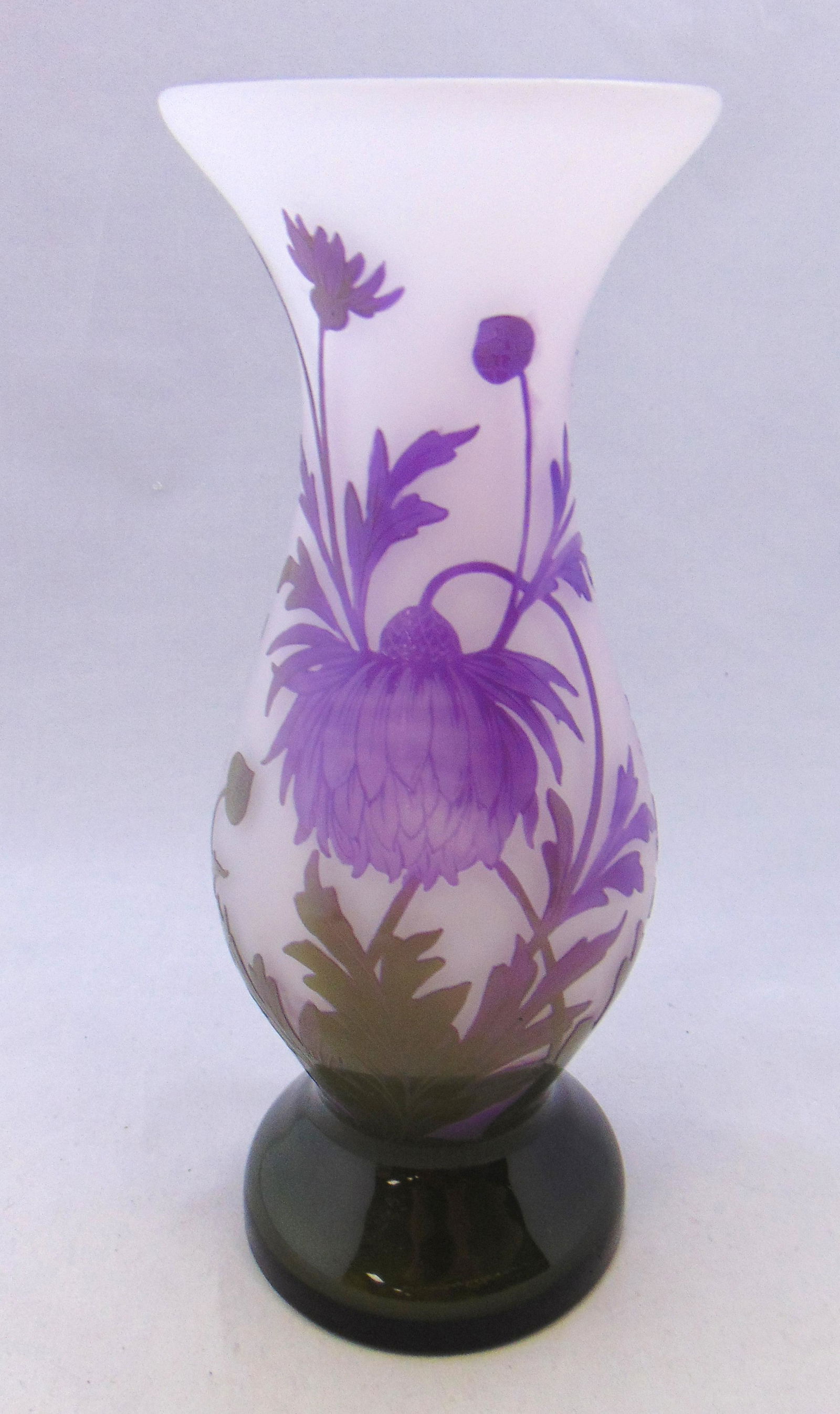Art French cameo glass vase: Footed corset form in white glass decorated with green to purple stemmed flowers and a teasing butterfly, signed in cameo Art 10 1/4" ht. PROVENANCE: Humler Nolan Condition: good with no defects found