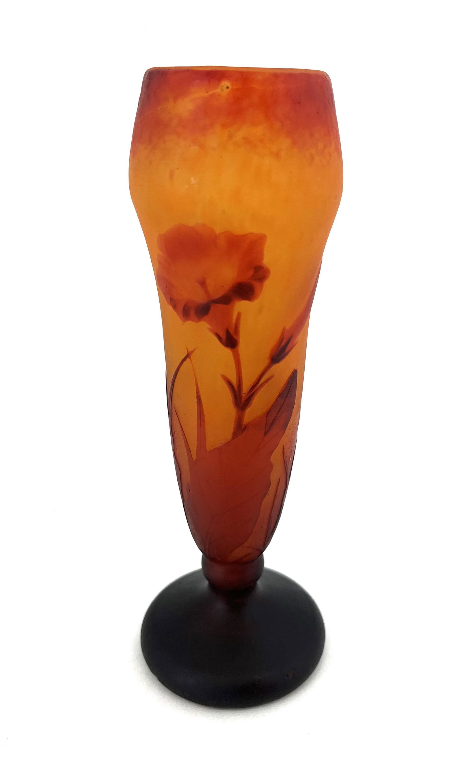 Daum Nancy French cameo glass vase: Daum Nancy footed cylindrical form in mottled red and orange glass decorated with a stemmed crimson flower, signed in cameo Daum Nancy, 8" ht. Condition: good with no defects found.