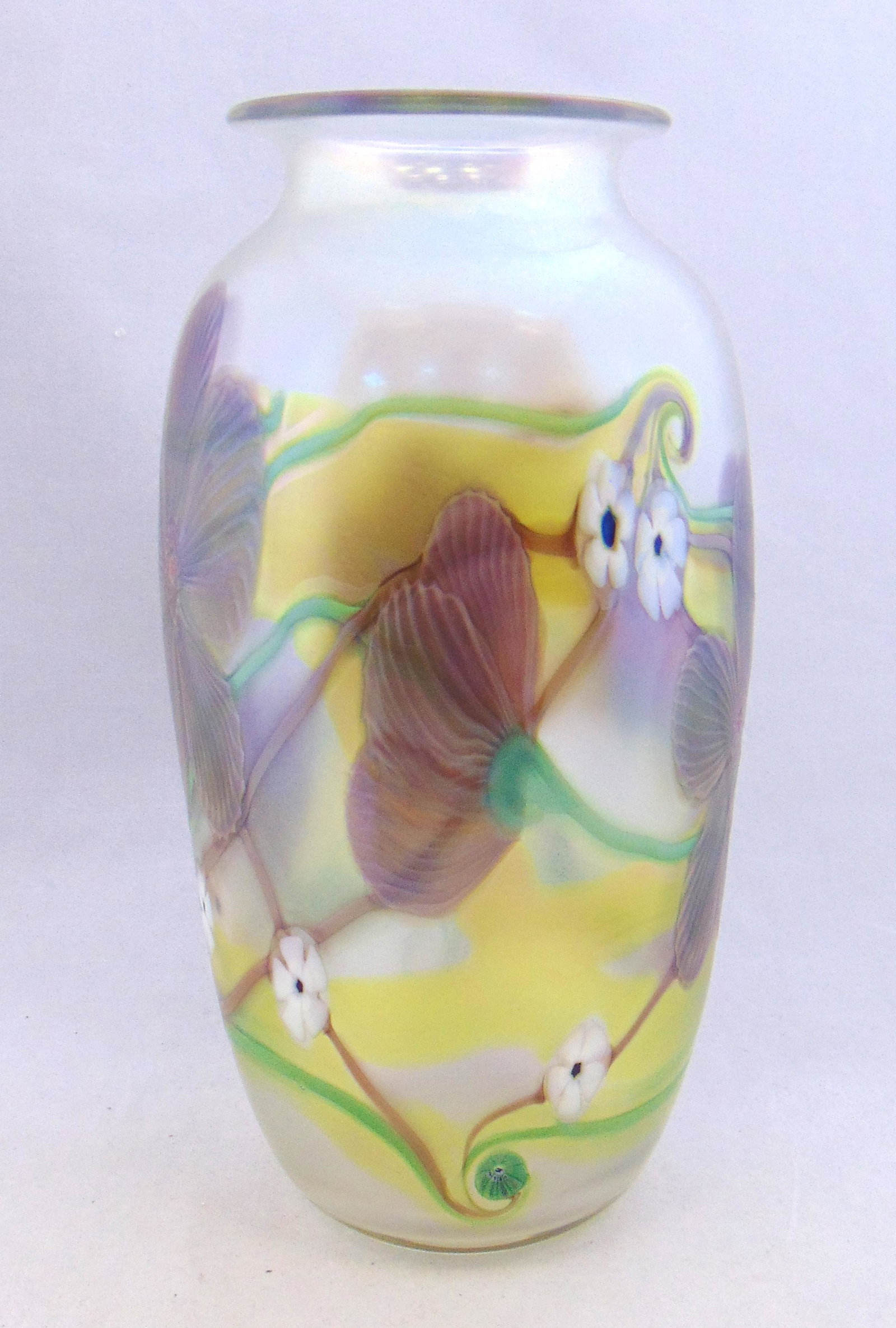 Orient and flume art glass vase: Shouldered form in Verre-de-Soie glass decorated with purple flowers and large white Millefiori, signed Orient and Flume and carries a Rosenstein retail label, 10 1/2" ht. Condition: good with no defe