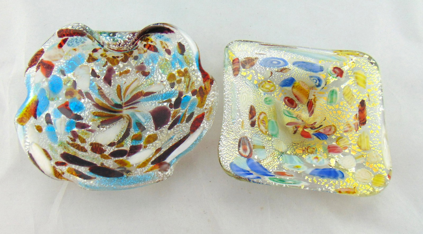 Pair of Murano glass bowls: Two Murano aventurine glass trays each with large colorful cain spatter, largest 8" wide. Condition: good with no defects found.