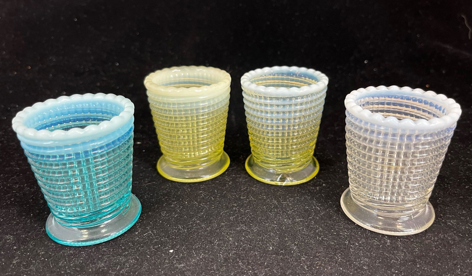 Four Ribbed Spiral glass toothpicks: Four Ribbed Spiral glass toothpicks by National, 2 3/8" ht. Literature: Bredehofts/the Sanfords - Glass Toothpick Holders, Second Edition, p. 149. CONDITION: chip to the foot of the blue and one of th