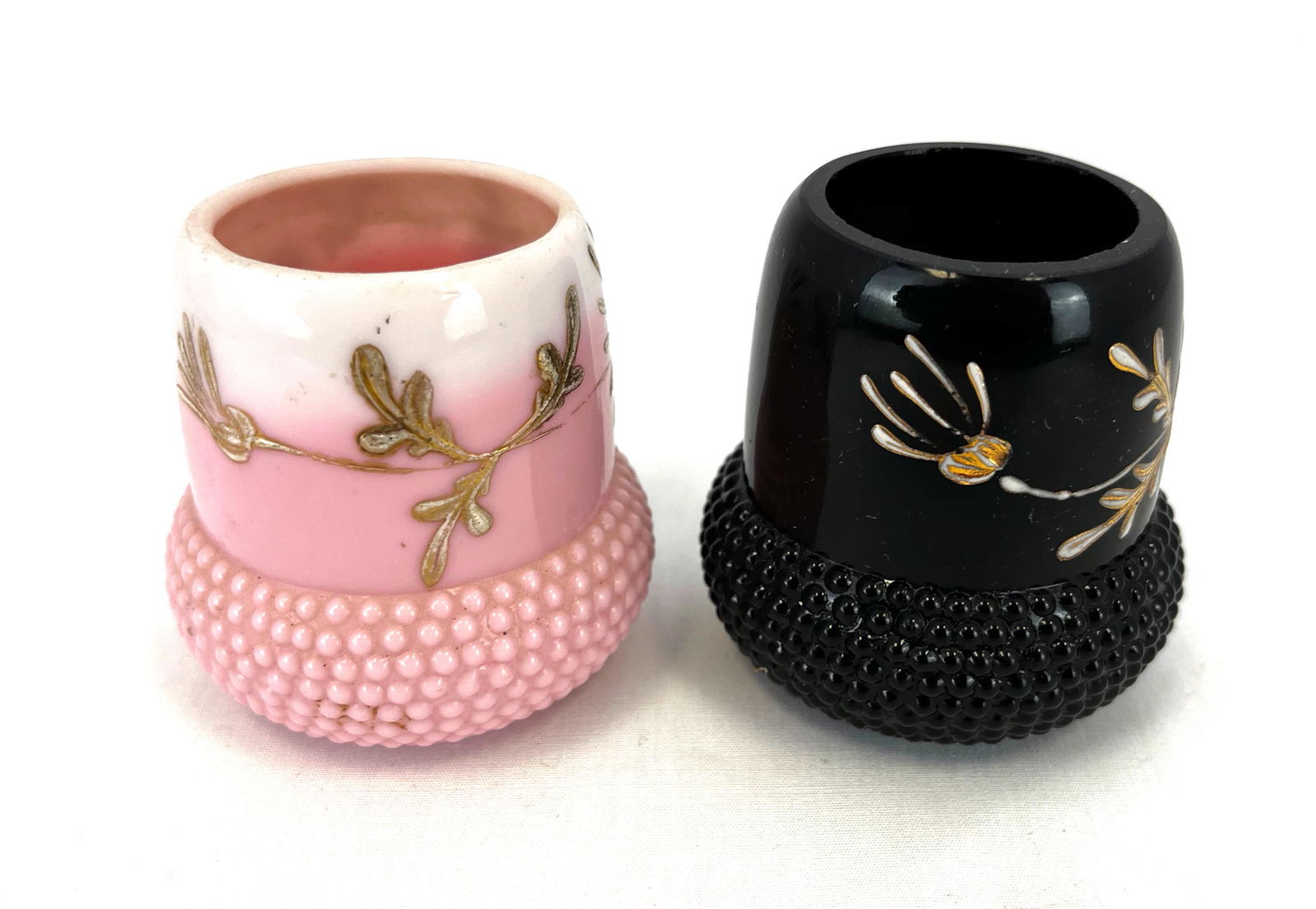 Two Acorn glass toothpick holders: Two Challinor Taylor and Co toothpick holders in the Acorn pattern, one in black and one in roseblush, 2 1/4" ht. Literature: Bredehofts/the Sanfords - Glass Toothpick Holders, Second Edition, p. 41.