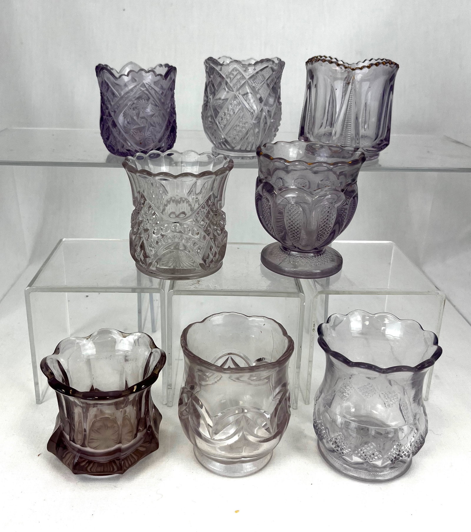 8 sun blush purple glass toothpicks: Eight sun blush EAPG purple toothpicks including Dolton, Essex, Juno, Double Arch, Widmer, Texas, Egyptian, and a Ladders, tallest 2 3/4" ht. Condition: good with minor wear