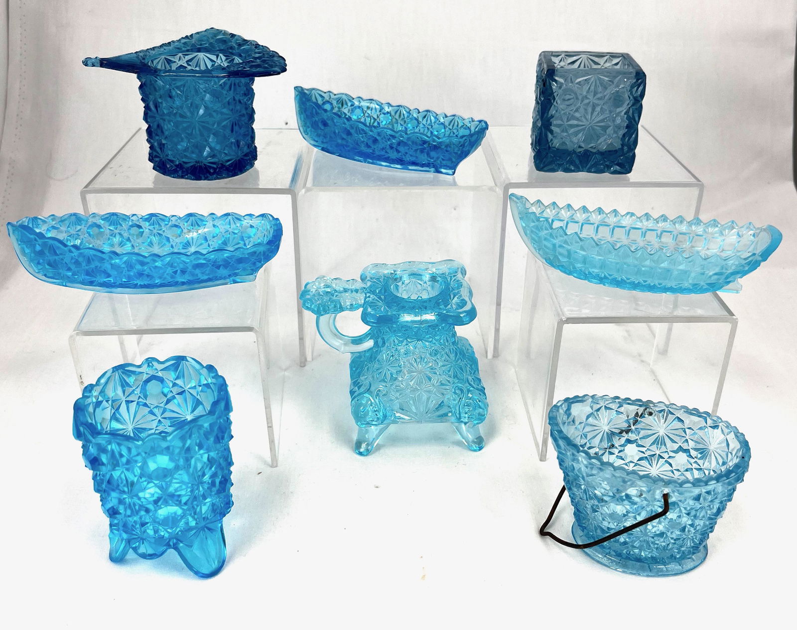 Group of blue Daisy and button items: Group of Prussian Blue daisy and button glass items including a footed candle holder, fan rim hat toothpick, Hobbs footed toothpick, three boats, a rectangular toothpick and a coal bucket. CONDITION: