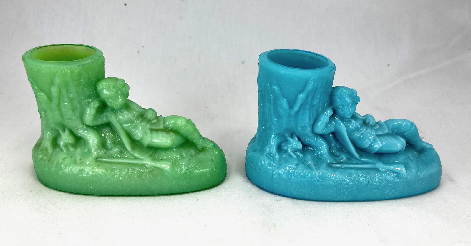 Two Portieux figural toothpick holders: Two French Portieux figural toothpicks with the Hunter or Rip Van Winkle dŽcor, one in blue opaque and one in green, 3" ht. CONDITION: chip to the base of the blue one.
