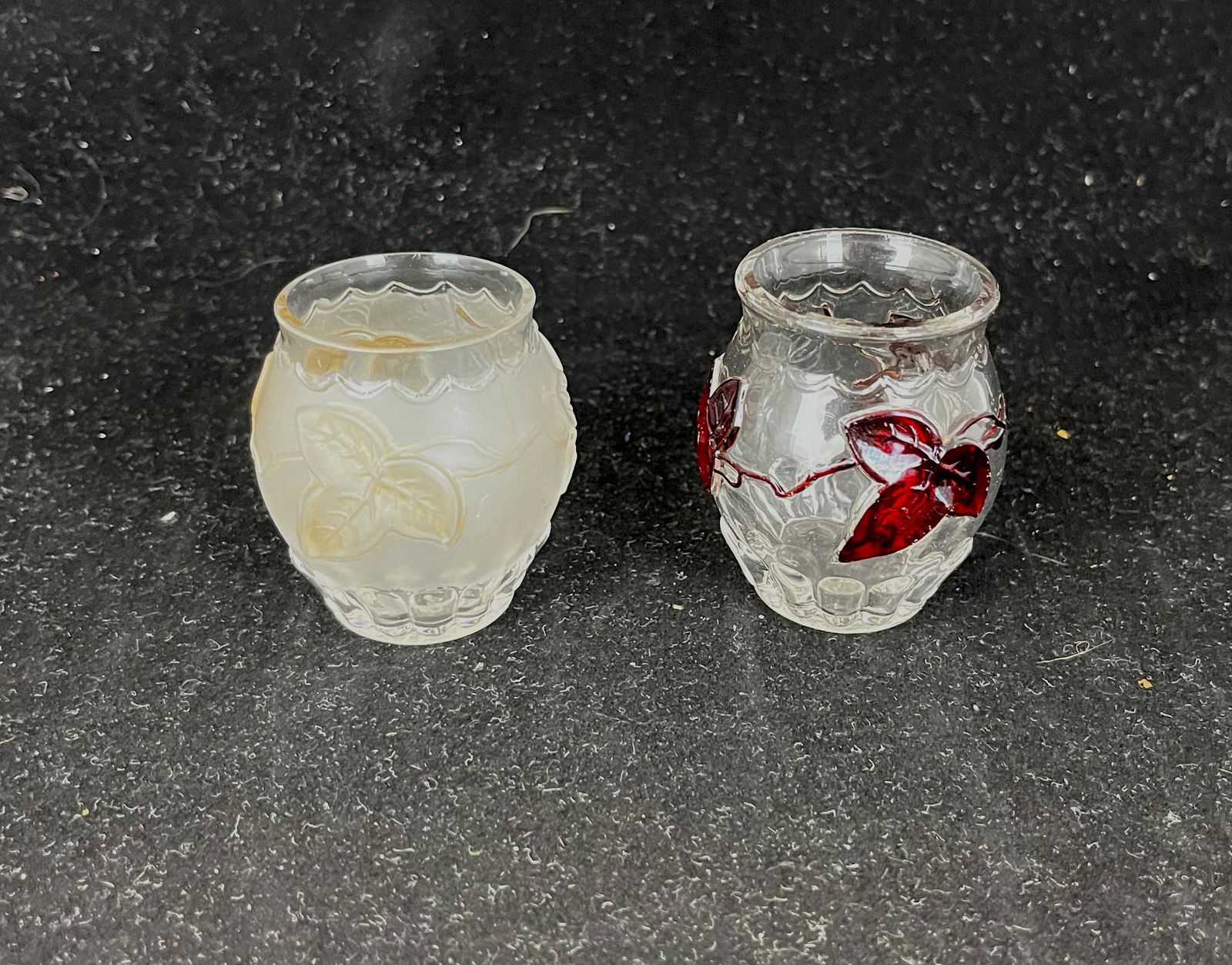 Two flower and peat toothpick holders: Two flower and peat toothpick holders, one frost with amber leaves, one clear with red leaves; 2 1/4" ht. Literature: Bredehofts/the Sanfords - Glass Toothpick Holders, Second Edition, p. 215. CONDITI