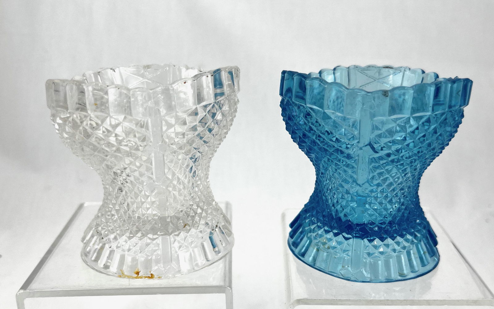 Two Bellaire Corsett toothpick holders: Two Bellaire Corsett toothpick holders including two Bellaire one in clear and one in blue; 3" ht. Literature: Bredehofts/the Sanfords - Glass Toothpick Holders, Second Edition, p. 22. CONDITION: good